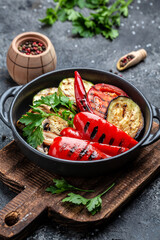 Barbecue menu. Grilled vegetables in a cast iron grilling pan, Vegan cuisine, vertical image. top view. place for text