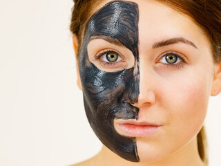 Woman with charcoal facial mask