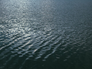 Sea surface, water waves at sunset