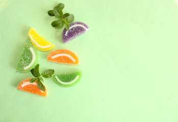 Colorful fruit jelly candies on color background top view 