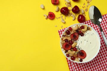 Concept of tasty breakfast with yogurt on yellow background