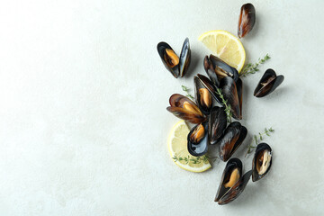 Fresh mussels on white textured background, space for text