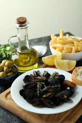 Concept of delicious food with mussels on black smokey table