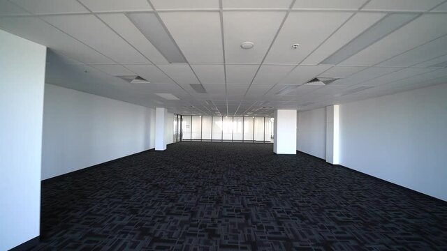 Vast empty room with white walls and carpet for modern office, dolly forward