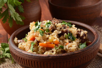Fried and stewed beef meat with rice. Uzbek cuisine  pilaf (plov)