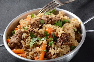 Fried and stewed beef meat with rice. Uzbek cuisine  pilaf (plov)