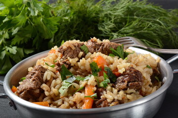 Fried and stewed beef meat with rice. Uzbek cuisine  pilaf (plov)