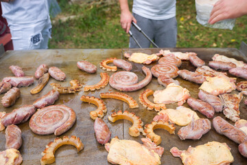 detail of pieces of mixed meat on the plate. Sausage, cevapcici, chicken and bacon