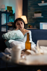 Depressed, frustrated, stressed, traumatised woman sitting alone holding pillow feeling emotionally vulnerable, lonely desperate, scared suffering from break up having anxiety, mental health problems