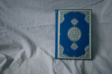 The Qur'an is the holy book in Islam on the table 