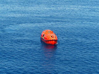 Offshore Life boat or survival craft at muster station of oil and gas drilling rig.