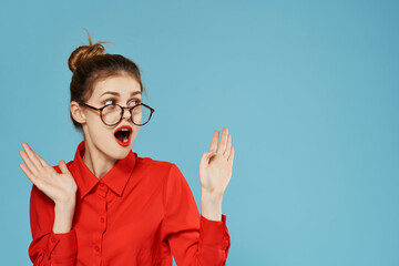 emotional business woman in red shirt wearing glasses gesturing with hands work