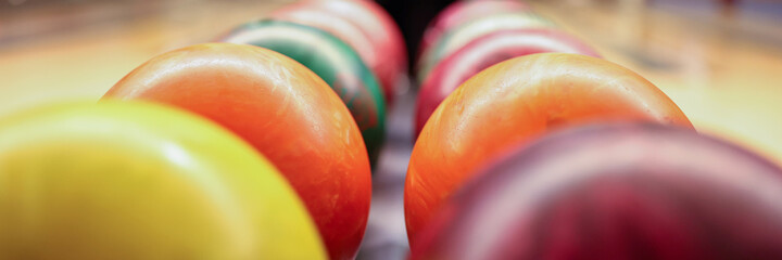 Colorful balls on rack in bowling club closeup