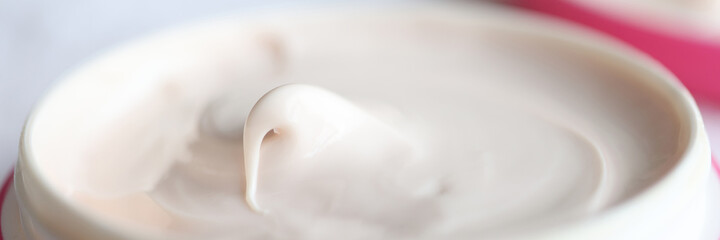 Fototapeta na wymiar Closeup of pink jar of moisturizing cream