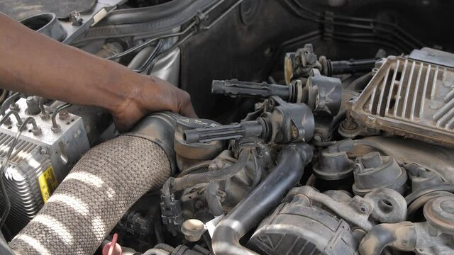 24th may 2021, Lagos Nigeria: Africa local Mechanic Is Checking and repairing the engine of cars and truck at the mechanic Motor garage .