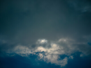 Fototapeta na wymiar Full moon among clouds in the night sky.