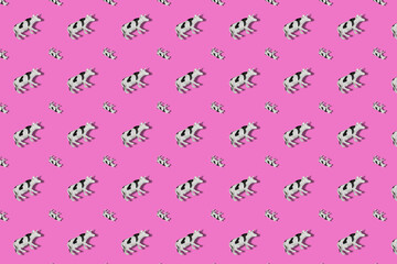 Repeating Toy Cow on a colored background. Black and white spott