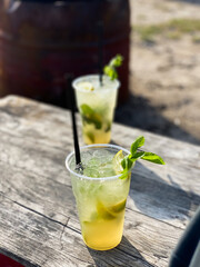 Two glasses of mojito on a table in the sun during a relaxing evening with friends
