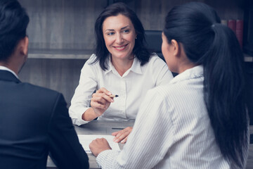 Asian Senior businesswoman meeting to discuss work plans with team members Brainstorming in the meeting room. Consulting on ideas, finance, business investment. happiness at work
