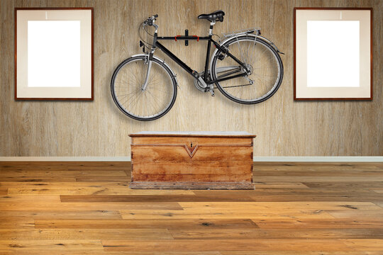 Old-fashioned wooden chest against textured wood wall with a Hanging road bike