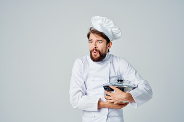 male professional chef with a saucepan in his hands preparing food restaurant