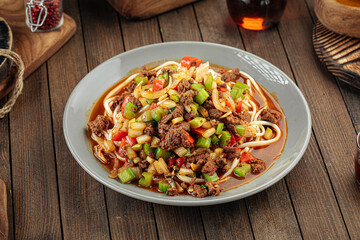 Asian uyghur dish suiru lagman noodles on a wooden background