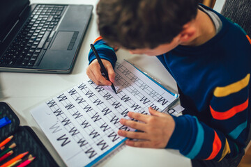 Child practicing writing at home.
