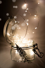 Glass jar with lights inside. The concept of New Year and Christmas. Vertical image.