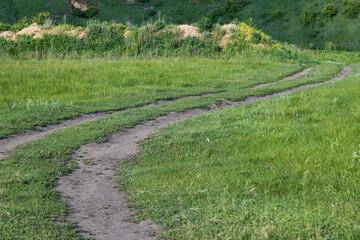 Fototapeta na wymiar path among the hills as a background