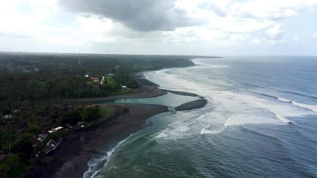 Fly around black sand Bailan beach before storm in Bali. High quality 4k aerial footage