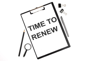 On a white background magnifier, a pen and a sheet of paper with the text TIME TO RENEW . Business concept