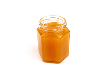 Glass jar full of sweet honey isolated on white background