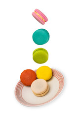 Colorful macaroons floating on a ceramic saucer. Food levitation concepts.