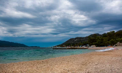 Foto op Canvas Dark stormy clouds gather above a popular windsurfing beach in Peljesac, Croatia © helivideo