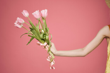 bouquet of pink flowers Woman hands close up pink background romance