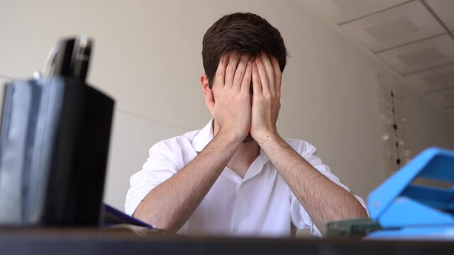 Upset Businessman In The Office Worried About Investment Problem. low angle