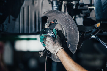 man changes a wheel hub with a wheel bearing in a car