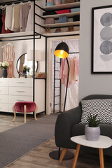 Modern wardrobe room interior with stylish furniture