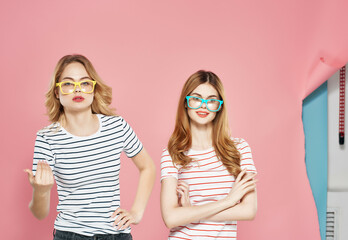 Obraz premium two girlfriends stand side by side charm fun lifestyle isolated background