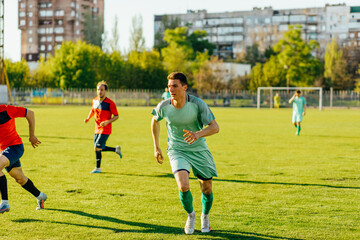 Sports soccer players in training, male soccer players kick soccer balls in training, on training soccer field