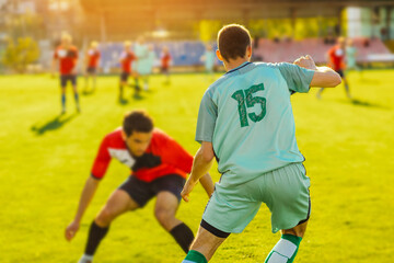 Fototapeta premium football players in action at the stadium, Football game for adults, Players of two teams competing for the ball