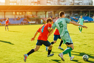 football players in action at the stadium, Football game for adults, Players of two teams competing for the ball