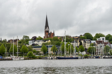Sail boats in the port of Flensburg, St. Jorgen's Church in the background. Schleswig-Holstein in Germany