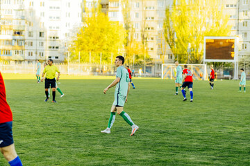 Soccer training, young male soccer players training playing soccer, athletes running and hitting soccer balls