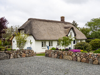 Traditional Frisian thatched cottage in the village of Nebel on the island of Amrum, Germany