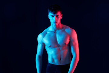 photograph of a man with athletic physique and neon skin color isolated background cropped view