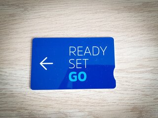 Closeup shot of a blue hotelâ€™s room key card isolated on a wooden surface