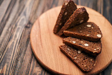 sliced whole-grain bread on a wooden board.