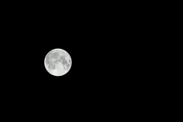 Full moon. Sturgeon moon isolated on natural black night sky.