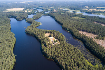 Aerial view of Mordanga lake with peninsula in sunny summer day, Latvia.